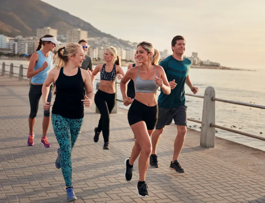 Portrait of young runners enjoying the workout on the seaside