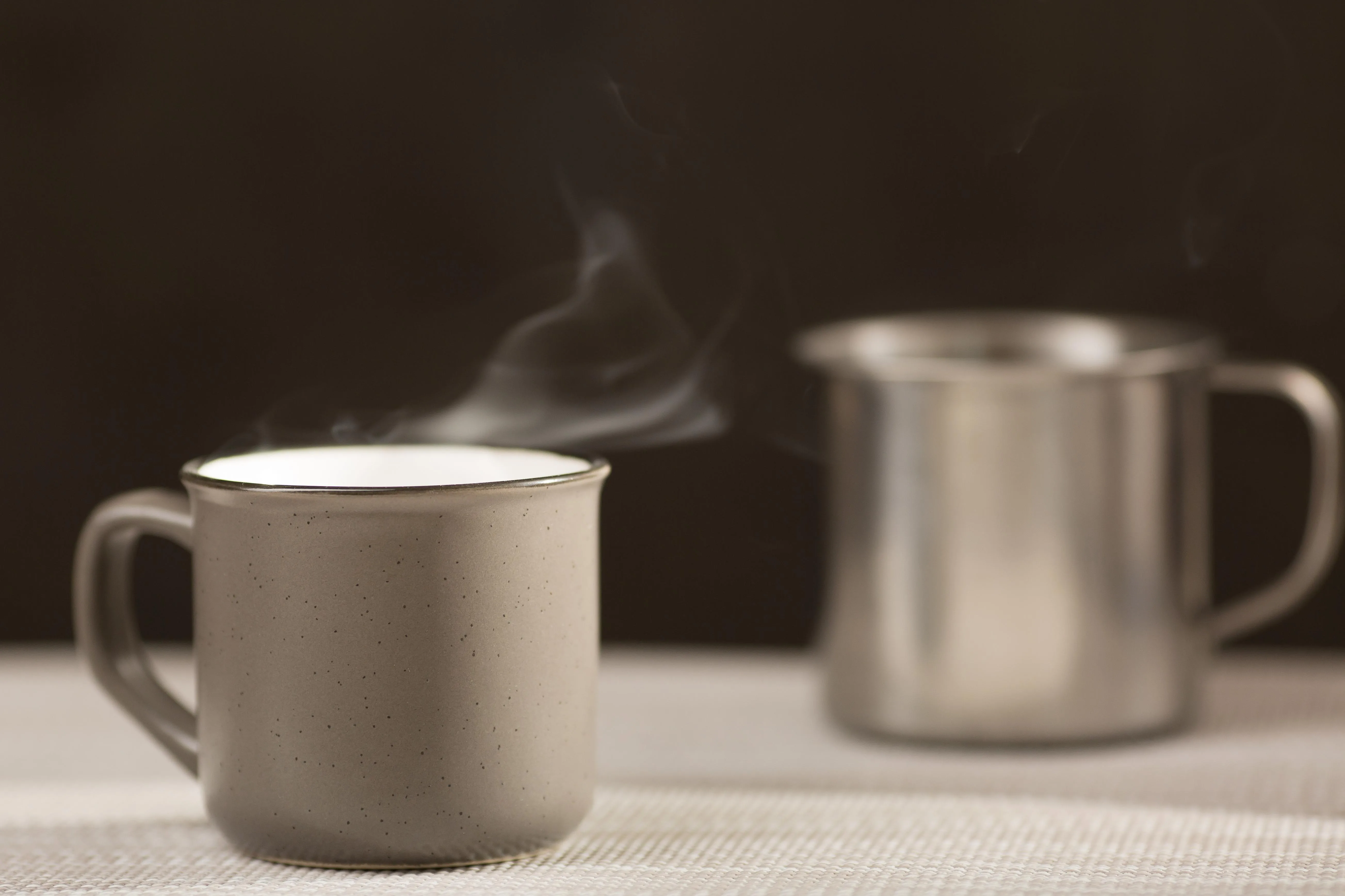 Two steaming mugs on a table after a cold-weather run