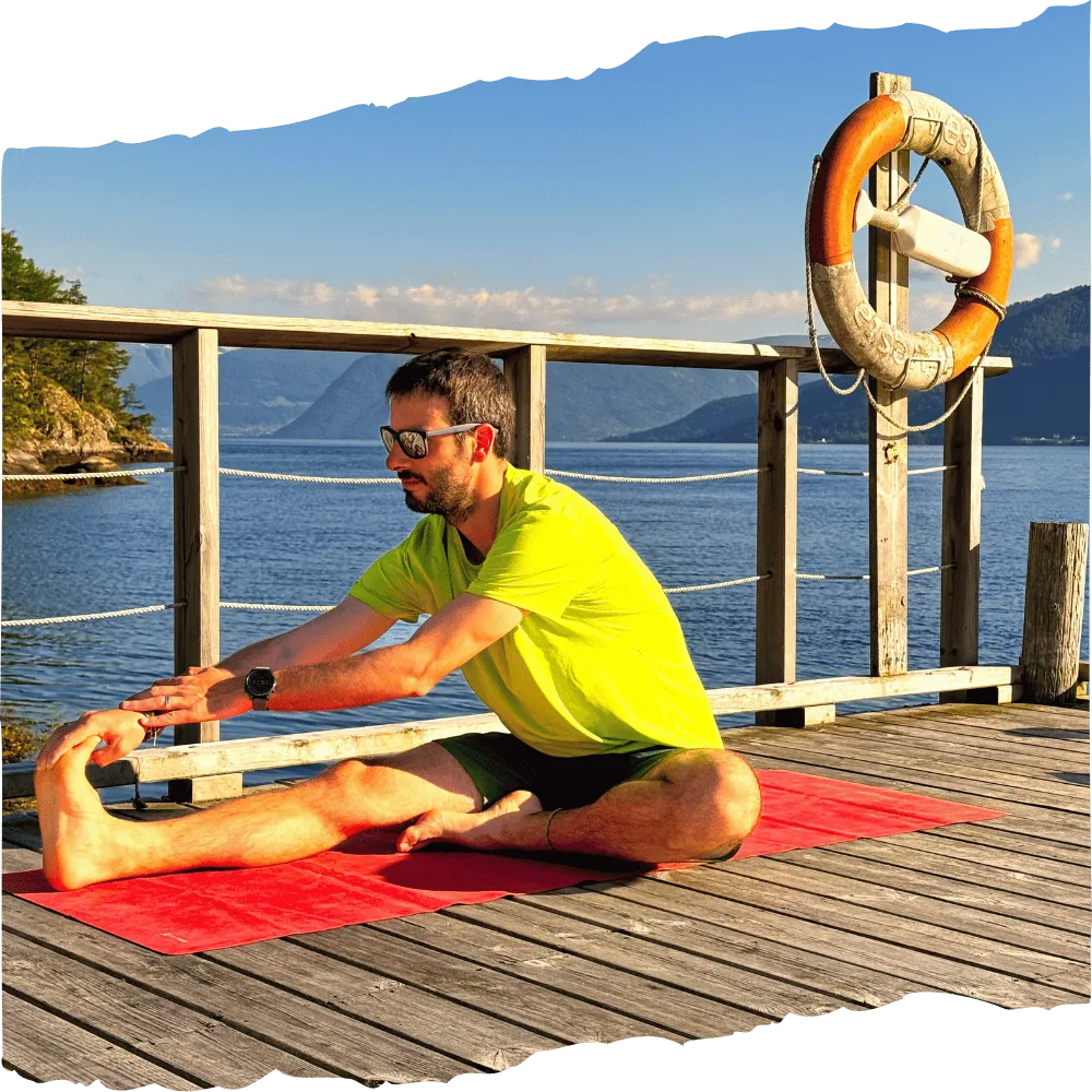 Runner doing stretching on a pier — start your personal running coaching today