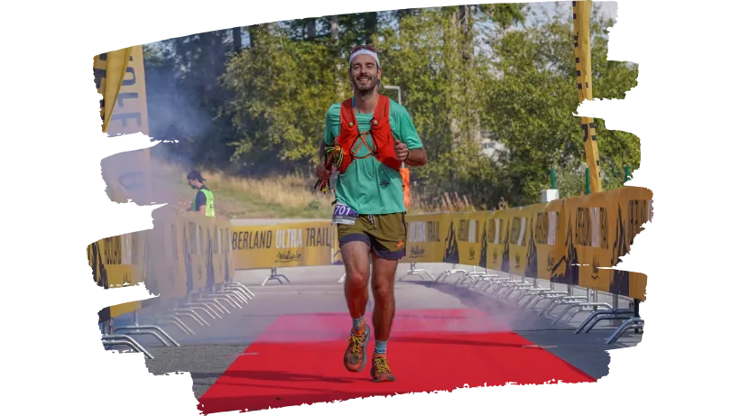 Runner crossing the finish line, trained with Future Athletes Running coaching in Munich